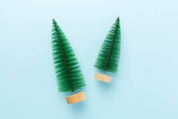 Small christmas tree on color background, top view