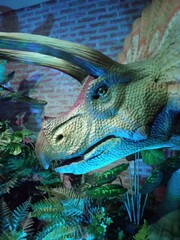 Mechatronic dinosaur with forest decoration around it