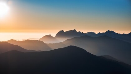 the silhouette of a mountain range outlined against the backdrop of a clear sunny sky