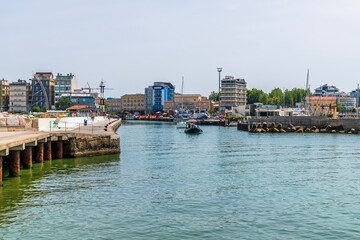 Fototapeta premium A view down the channel leading to the harbour at Gabicce Mare, Italy in summertime