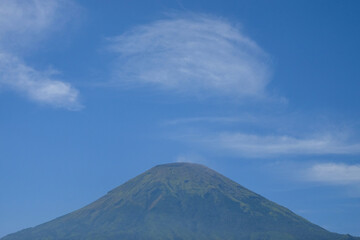 Fototapeta premium Landscape minimalist mountain blue sky background. Mount Sindoro, Central Java, Indonesia. Minimalist composition for graphic design