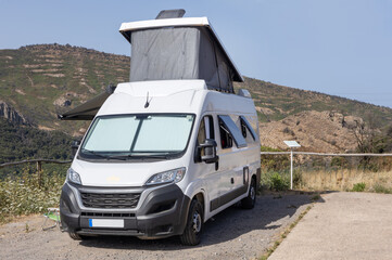 Camper Van Parked in Mountain Landscape