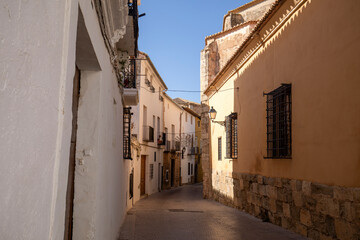 Fototapeta premium Typical street of the medieval old town of Requena, Valencian Community, Spain, with its whitewashed houses in summer
