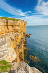 Dramatic cliffs overlooking tranquil blue waters on a sunny day in coastal landscape