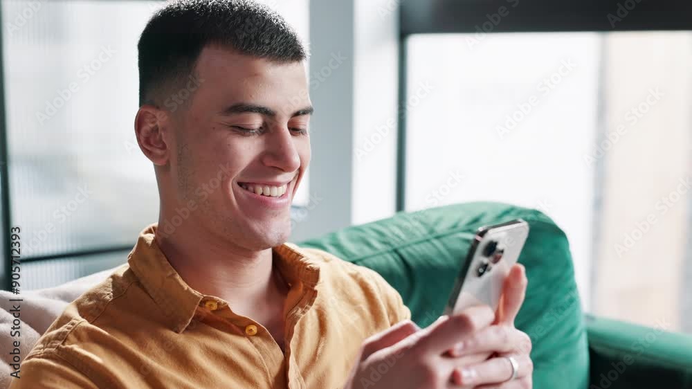 Poster phone, laughing and man on sofa in home networking on social media, mobile app or internet. happy, t