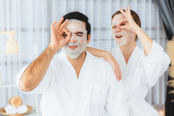 Serene modern daylight ambiance of spa salon, couple customer indulges in rejuvenating with facial...