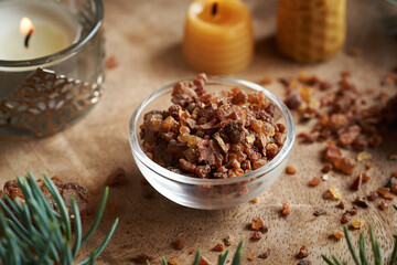 A bowl of myrrh resin on a table - ingredient for essential oils