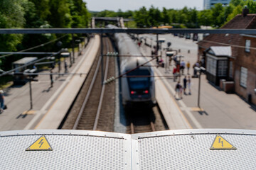 Railway. Yellow warning sign. A moving train against the background of a warning sign.