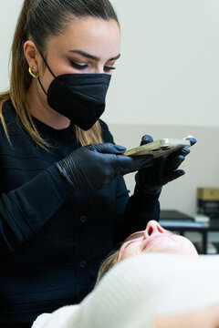 Beautician Taking Photos of Client's Eyebrows After Microblading