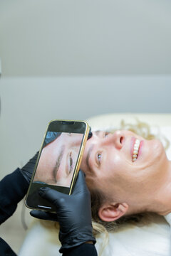 Beautician Photographing Microblading Results on Client