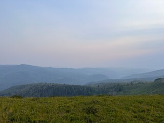 landscape with mountains and valley and smoke