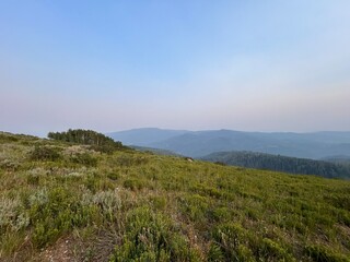 landscape with mountains and valley and smoke