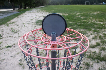 Disc Golf Basket With Chains on Sandy Grass