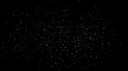Falling small transparent flakes of snow, a winter blizzard