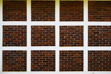 Background of brick wall. Architecture background with brick wall facade. Stone cladding wall background. Brick surface background for poster or banner. Wall design.