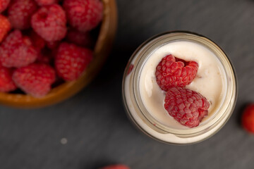 delicious and fresh yogurt with raspberry flavor and whole red raspberries