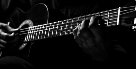 Fototapeta premium Black and White Close-Up of Guitar Being Played Focus on Fretboard