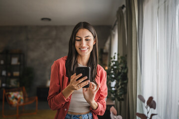 Portrait of adult young woman stand hold and use mobile phone