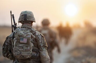 Soldiers Marching at Sunset With American Flags on Their Packs in a War Zone