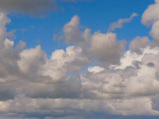 The sky is filled with clouds, but the sun is still shining through. Scene is peaceful and serene, as the clouds create a sense of calmness and tranquility. Nature background for design.