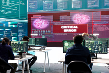 Hackers group failing to hack a system in high tech agency office, reading critical error message on big screen. Specialists trying to steal important database information from rival states.