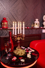 A beautiful Romantic Candlelit Setting adorned with Flowers and Grapes for special moments
