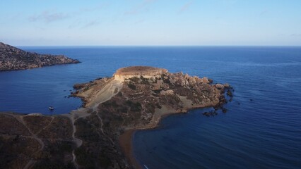 Qarraba Bay flat rock cape Malta, Aerial establishing shot in the morning sunlight. High quality photo