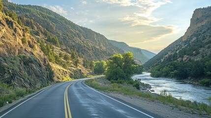 Scenic roadside view of a mountain highway with a river running alongside