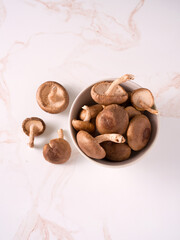 Overhead view of Shitake mushrooms in a white bowl; cancer fighting food; copy space