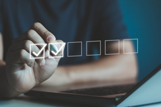 Checklist Concept with Businessman and Check Mark. Businessman is marking a check on a virtual checklist, representing task completion and organization in a professional business setting, filling out.