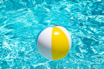 Summer swimming pool. Beach ball in swimming pool. Summer vacation advertising. Beach ball. Ball in the swimming pool. Summer vacation.