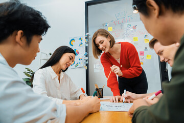 Creative happy business team brainstorming and sharing idea by using mind map and graphic graph...