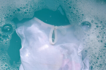 Fototapeta premium White cloth soaked in powder detergent water dissolution, washing cloth. Laundry concept