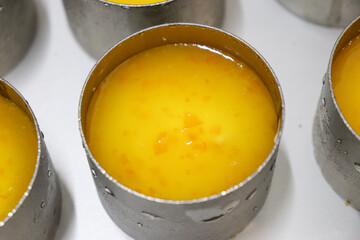 丸形にオレンジのソースを注ぎ冷やし固める