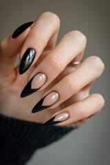 Elegant black stiletto nails with a glossy finish and transparent heartshaped tips