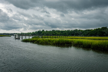 Landscape of marsh or swamp lowlands and water channels of brackish water outside of Charleston, South Carolina right before storm