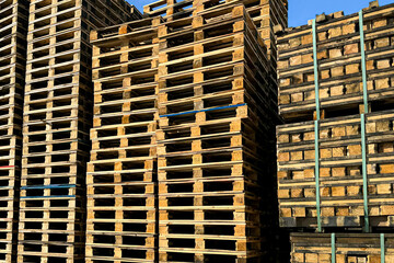 Wooden pallets. Factory and carefully arranged tall stacks of wooden pallets, ready for...