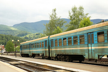 Obraz premium Old train on railway station in mountains
