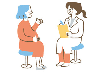 A woman talking to a female doctor during a pregnancy checkup_Color