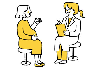 A woman talking to a female doctor during a pregnancy checkup