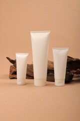 White Cosmetic Tube with Eucalyptus Leaves on Beige Background for Natural Skincare Mockup