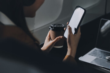 A young Asian woman, seated as an airplane passenger, contemplates dollar bills, reflecting on lucrative opportunities and aspirations towards billionaire status.