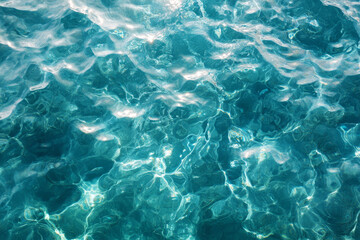 Fototapeta premium Water texture background with ripples and reflections in turquoise water