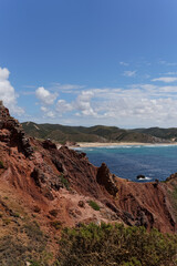 Colorful Rock Formations along the Vibrant Blue Portuguese Coastline with Cloudy Sky