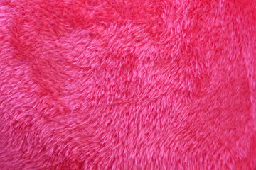Artificial red fur texture with bright soft smooth patterns on background