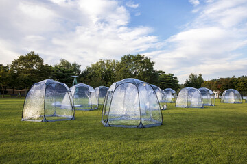 Tappyeong-ri, Chungju-si, Chungcheongbuk-do, South Korea - September 23, 2022: Summer view of transparent vinyl tents on the grass at Jungangtap Historical Park
