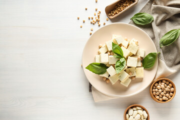 Tofu in a bowl with beans and soy on a light background