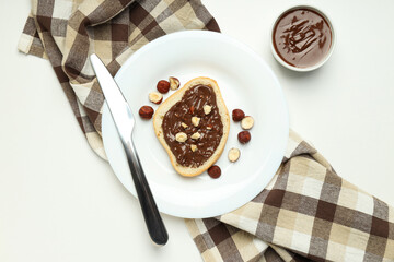 Bread with chocolate paste in a bowl on a light background