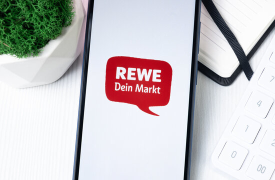 New York, USA - 1 August 2024: REWE Logo on Phone Screen, Company Icon on Display