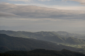 The sky is cloudy and the mountains are in the background